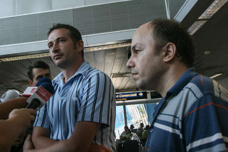 Bucharest, Romania, August 14, 2009: Members of the Italian towboat Buccaneer who were kidnapped by Somali pirates in Aden Gulf on August 9-10, are welcomed by their families and press representatives on the Henri Coanda airport.のeditorial素材