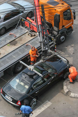 Bucharest, Romania, July 30, 2009: The municipality services evacuate illegally parked car in Bucharest.のeditorial素材