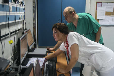 Bucharest, Romania, July 23, 2009: Two medics are working in the coordination center of an emergency hospital.のeditorial素材