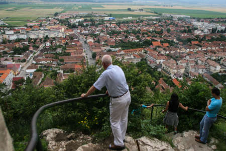 Rasnov, Romania, July 4, 2009: Visitors are looking at the panorama of Rasnov city from the Rasnov citadel, Romania.のeditorial素材