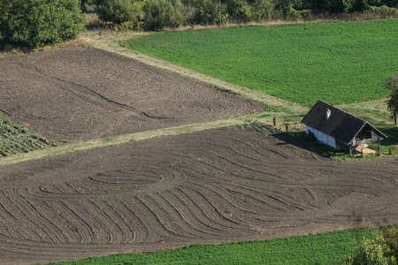 Saschiz, Mures County, Romania, September 27, 2009: Aerial view of a small traditional house on a field, in Saschiz village, Mures Countyのeditorial素材
