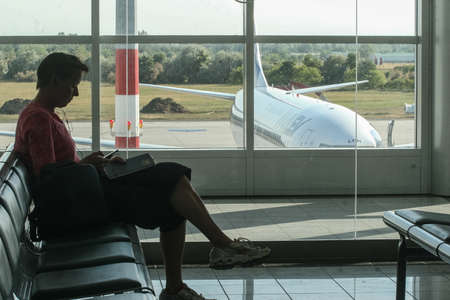 Budapest, Hungary, May 24, 2009: A woman is waiting on a bench in the  Budapest Ferenc Liszt International Airport.のeditorial素材