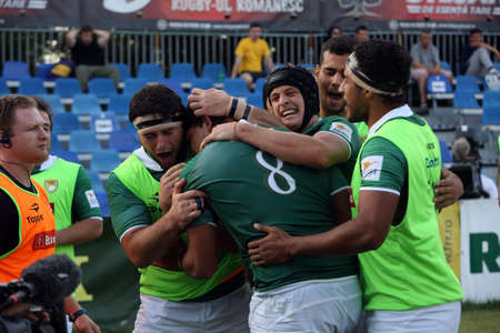 BUCHAREST, ROMANIA - June 24, 2017: Andre Arruda from Brasil is celebrated by his team mates after grounding the ball in rugby test game between Romania and Brasil, won by Romania with 56 to 5.のeditorial素材