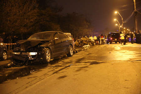 BUCHAREST, ROMANIA - November 07, 2017: Police, forensics inspect car burned after an accident. Two burnt to death when the car erupted in flames after a drunk driver hit a car and crashed.のeditorial素材