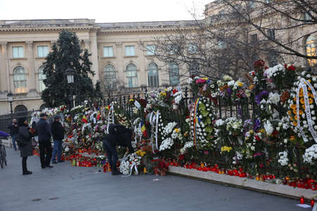 BUCHAREST, ROMANIA  - December 09, 2017: Citizens are bringing flowers and light candles as a last...