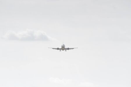 BUCHAREST, ROMANIA - August 15, 2017: Airplane in the cloudy sky.のeditorial素材