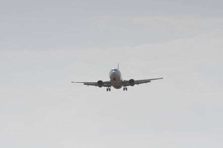 BUCHAREST, ROMANIA - August 15, 2017: Airplane in the cloudy sky.のeditorial素材