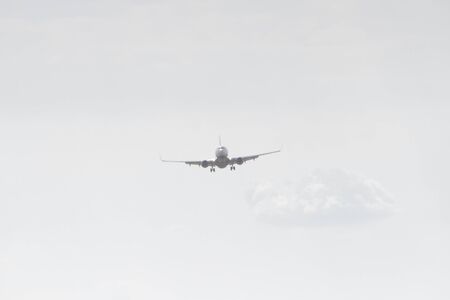BUCHAREST, ROMANIA - August 15, 2017: Airplane in the cloudy sky.のeditorial素材