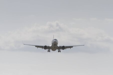 BUCHAREST, ROMANIA - August 15, 2017: Airplane in the cloudy sky.のeditorial素材