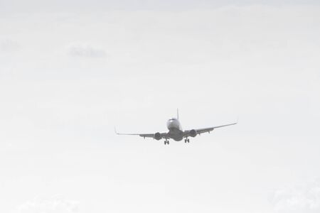 BUCHAREST, ROMANIA - August 15, 2017: Airplane in the cloudy sky.のeditorial素材
