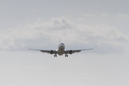BUCHAREST, ROMANIA - August 15, 2017: Airplane in the cloudy sky.のeditorial素材