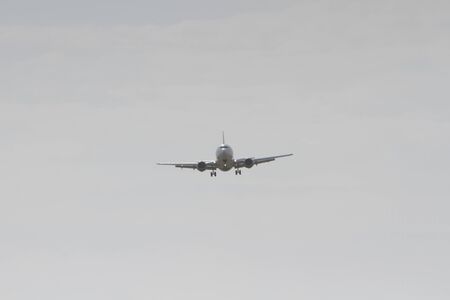 BUCHAREST, ROMANIA - August 15, 2017: Airplane in the cloudy sky.のeditorial素材