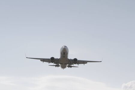 BUCHAREST, ROMANIA - August 15, 2017: Airplane in the cloudy sky.のeditorial素材