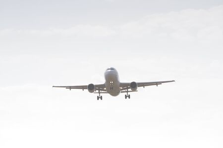 BUCHAREST, ROMANIA - August 15, 2017: Airplane in the cloudy sky.のeditorial素材