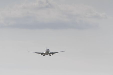 BUCHAREST, ROMANIA - August 15, 2017: Airplane in the cloudy sky.のeditorial素材