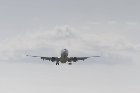 BUCHAREST, ROMANIA - August 15, 2017: Airplane in the cloudy sky.のeditorial素材