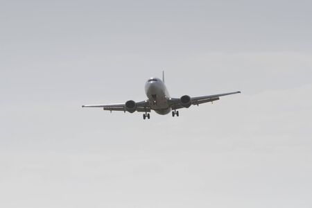 BUCHAREST, ROMANIA - August 15, 2017: Airplane in the cloudy sky.のeditorial素材