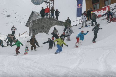 SIBIU, ROMANIA - March 13, 2010: Group of tourists having fun while snowboarding at Balea lake, Fagaras mountains.のeditorial素材