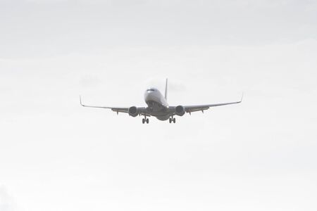 BUCHAREST, ROMANIA - August 15, 2017: Airplane in the cloudy sky.のeditorial素材