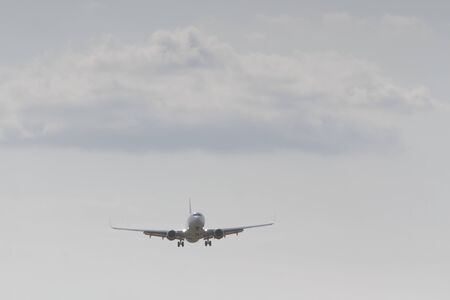 BUCHAREST, ROMANIA - August 15, 2017: Airplane in the cloudy sky.のeditorial素材