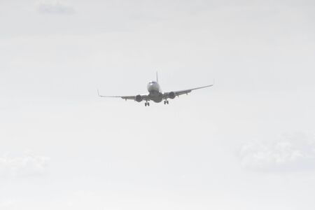 BUCHAREST, ROMANIA - August 15, 2017: Airplane in the cloudy sky.のeditorial素材