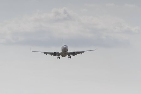 BUCHAREST, ROMANIA - August 15, 2017: Airplane in the cloudy sky.のeditorial素材