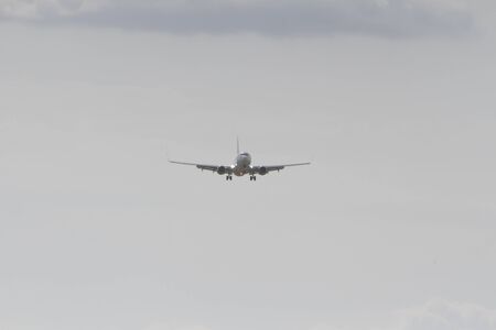 BUCHAREST, ROMANIA - August 15, 2017: Airplane in the cloudy sky.のeditorial素材