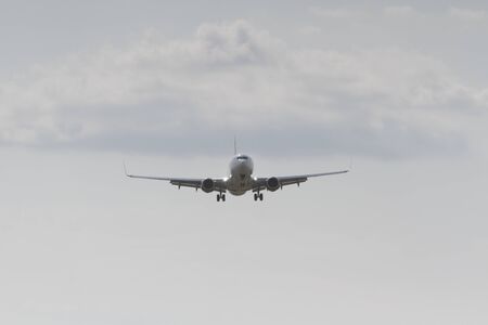 BUCHAREST, ROMANIA - August 15, 2017: Airplane in the cloudy sky.のeditorial素材