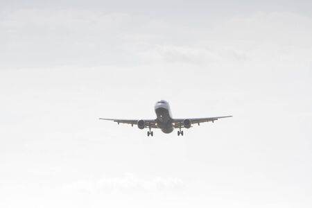 BUCHAREST, ROMANIA - August 15, 2017: Airplane in the cloudy sky.のeditorial素材