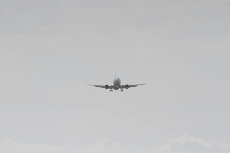 BUCHAREST, ROMANIA - August 15, 2017: Airplane in the cloudy sky.のeditorial素材