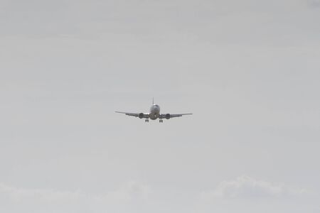 BUCHAREST, ROMANIA - August 15, 2017: Airplane in the cloudy sky.のeditorial素材