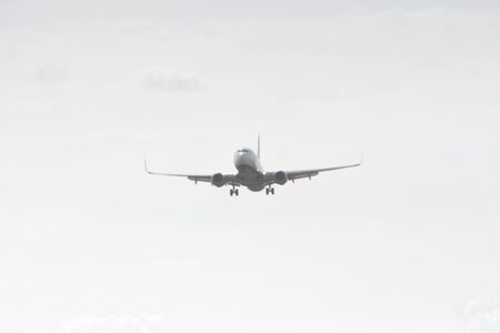 BUCHAREST, ROMANIA - August 15, 2017: Airplane in the cloudy sky.のeditorial素材
