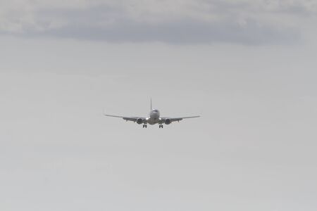 BUCHAREST, ROMANIA - August 15, 2017: Airplane in the cloudy sky.のeditorial素材