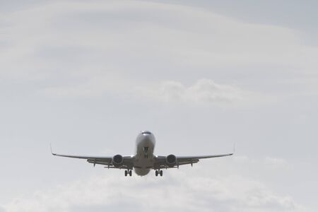 BUCHAREST, ROMANIA - August 15, 2017: Airplane in the cloudy sky.のeditorial素材