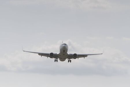 BUCHAREST, ROMANIA - August 15, 2017: Airplane in the cloudy sky.のeditorial素材