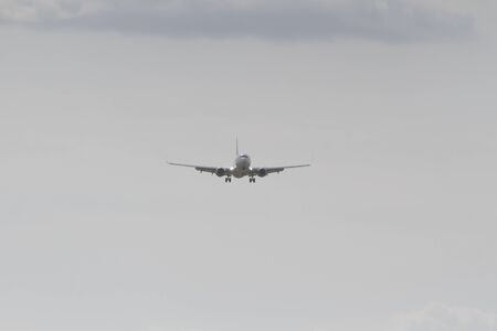 BUCHAREST, ROMANIA - August 15, 2017: Airplane in the cloudy sky.のeditorial素材