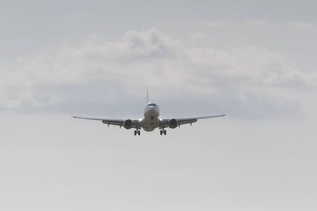 BUCHAREST, ROMANIA - August 15, 2017: Airplane in the cloudy sky.のeditorial素材