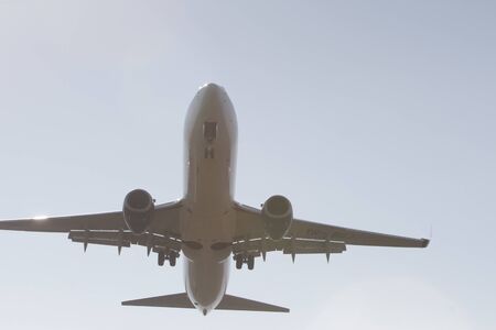 BUCHAREST, ROMANIA - August 15, 2017: Airplane in the cloudy sky.のeditorial素材