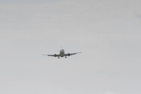 BUCHAREST, ROMANIA - August 15, 2017: Airplane in the cloudy sky.のeditorial素材