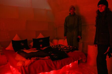 SIBIU, ROMANIA - March 13, 2010: People in bed room at Ice hotel, Balea lake, Fagaras mountains.のeditorial素材