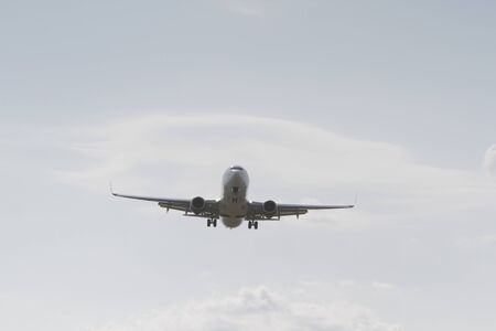 BUCHAREST, ROMANIA - August 15, 2017: Airplane in the cloudy sky.のeditorial素材