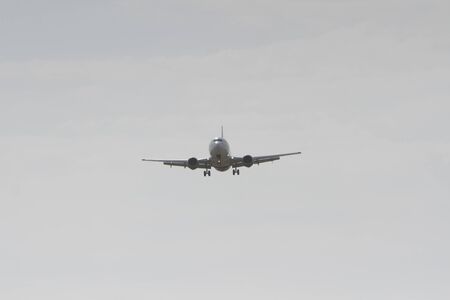 BUCHAREST, ROMANIA - August 15, 2017: Airplane in the cloudy sky.のeditorial素材