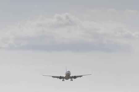 BUCHAREST, ROMANIA - August 15, 2017: Airplane in the cloudy sky.のeditorial素材