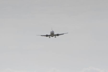 BUCHAREST, ROMANIA - August 15, 2017: Airplane in the cloudy sky.のeditorial素材