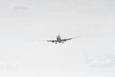 BUCHAREST, ROMANIA - August 15, 2017: Airplane in the cloudy sky.のeditorial素材