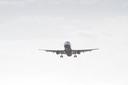 BUCHAREST, ROMANIA - August 15, 2017: Airplane in the cloudy sky.のeditorial素材
