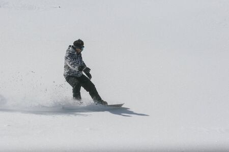 SIBIU, ROMANIA - March 13, 2010: Snowboarder running down the slope in Fagaras mountains.のeditorial素材