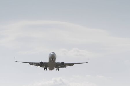 BUCHAREST, ROMANIA - August 15, 2017: Airplane in the cloudy sky.のeditorial素材