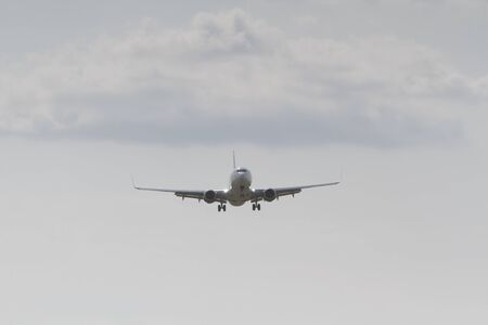 BUCHAREST, ROMANIA - August 15, 2017: Airplane in the cloudy sky.のeditorial素材