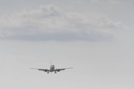 BUCHAREST, ROMANIA - August 15, 2017: Airplane in the cloudy sky.のeditorial素材